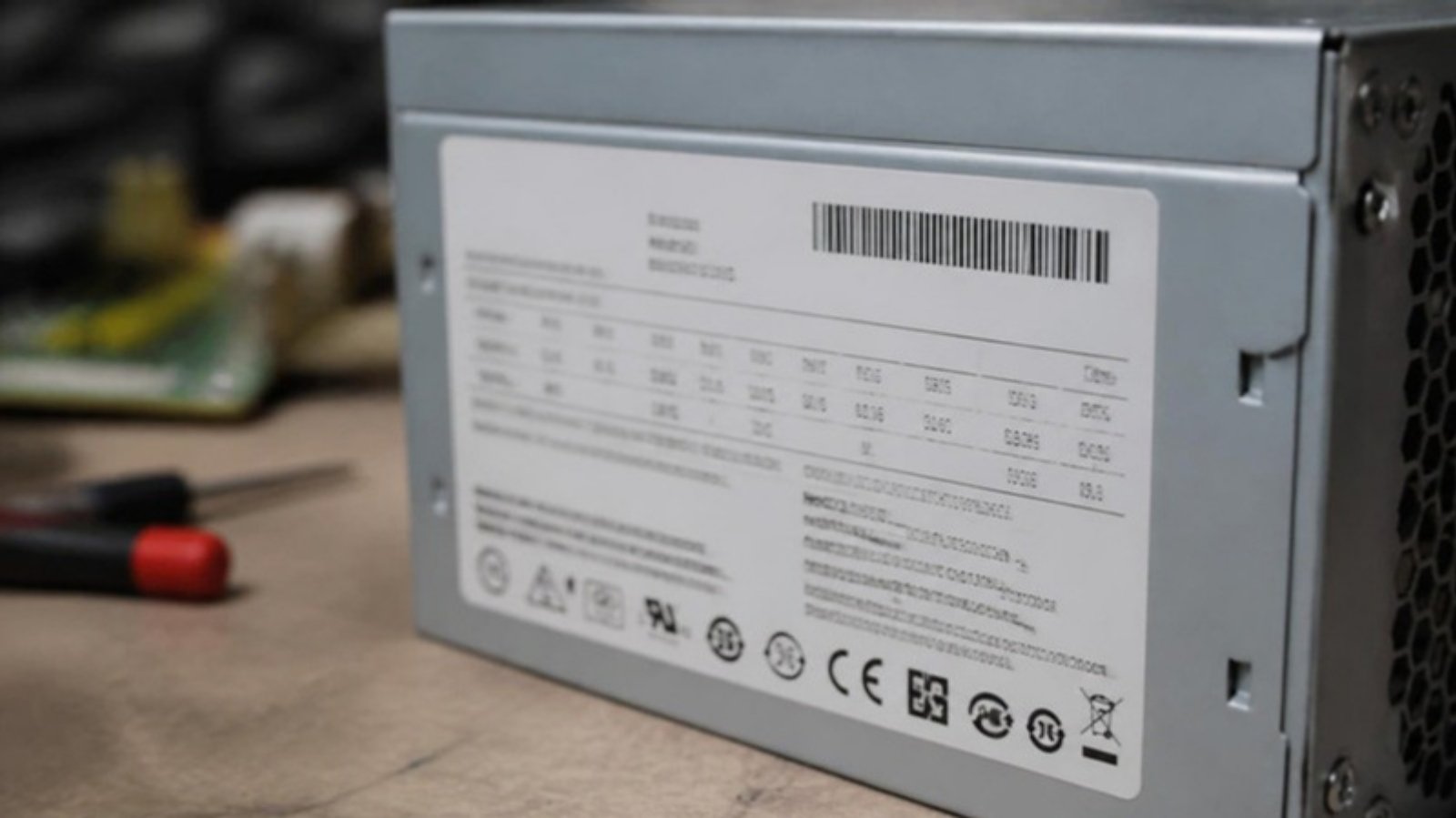 Close-up of a power supply label with barcode and part number details