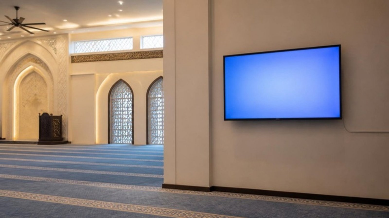 Wall-mounted screen in a mosque prayer hall fed by an HDMI extender