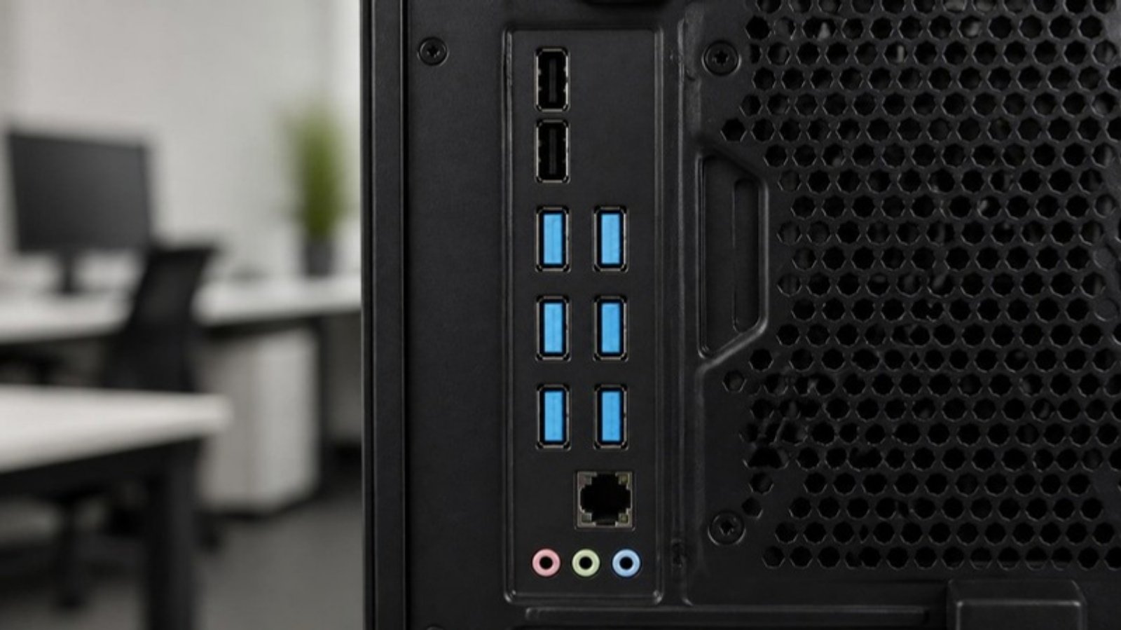 Rear USB-A ports of an office PC locked with blue port blockers